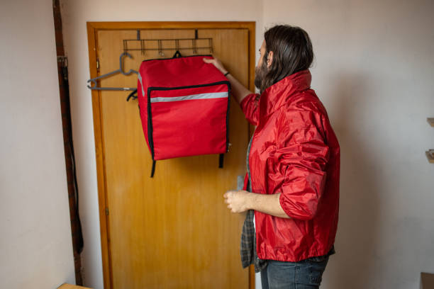 istock Male delivery person preparing for a work in the office 1404647761