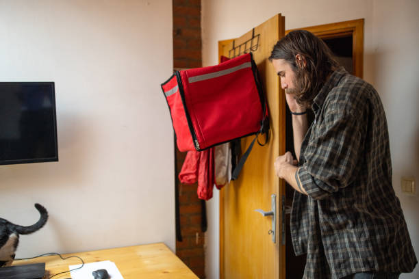 istock Male delivery person preparing for a work in the office 1404647762