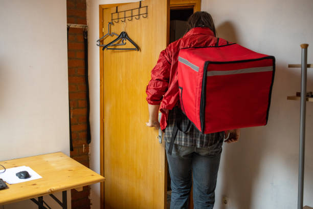 istock Male delivery person preparing for a work in the office 1404648416