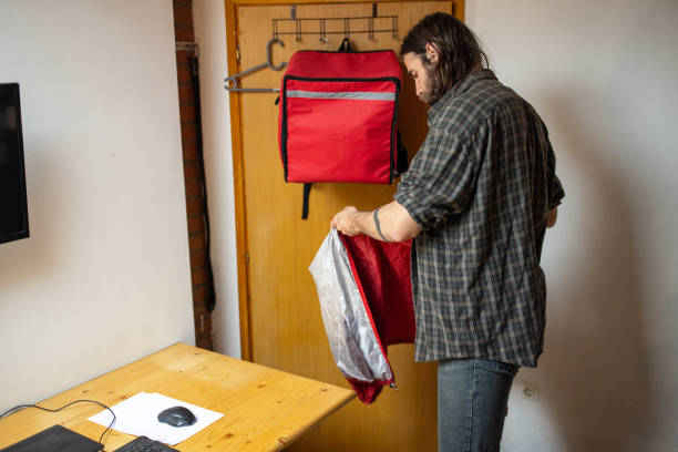 istock Male delivery person preparing for a work in the office 1404648417