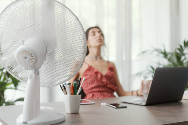 istock Woman cooling herself at home 1404648730