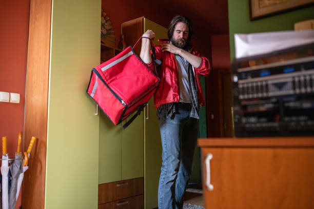 istock Male delivery person, leaving his home for work 1404648867
