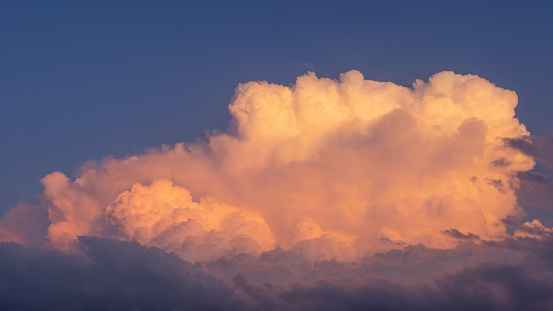 Thunderclouds in the sky in the light of the setting sun