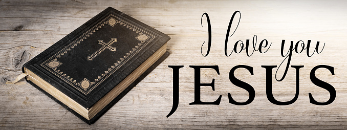 I love you JESUS - Church faith Christian background banner panorama - Old holy bible with cross on old rustic vintage wooden table with sunshine