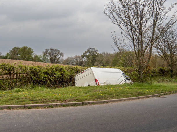 Unidentifiable white van in ditch, abandoned. Unidentifiable white van in ditch, abandoned by driver. UK. ditch stock pictures, royalty-free photos & images
