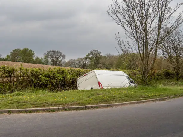 Unidentifiable white van in ditch, abandoned by driver. UK.