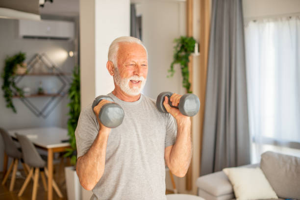 istock Senior man at home keeping fit by exercising 1404650306