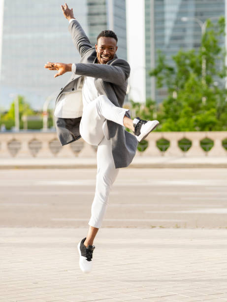 istock african american businessman jumping when leaving work 1404650507