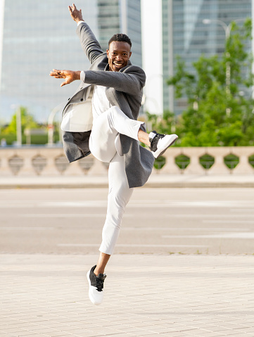 african american businessman jumping when leaving work