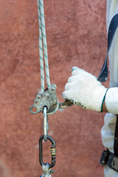 istock Climber builder adjusts safety carabiner, close-up 1404650903