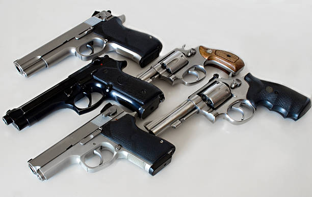 Multiple Guns Arsenal of a typical police officer. All logos and trademarks have been removed. forty five caliber handgun stock pictures, royalty-free photos & images