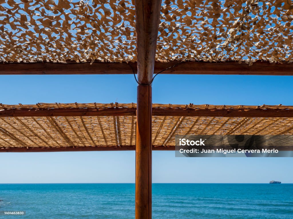 Pérgola de madera frente al mar Wooden pergolas in front of Malaga beach Architecture Stock Photo