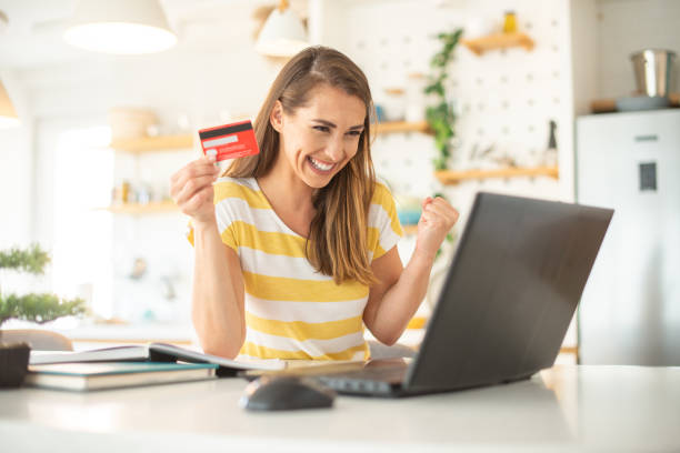 istock Cheerful  woman doing online shopping 1404654030