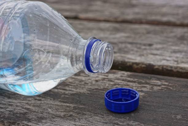 istock one white open plastic bottle with water and a blue stopper 1404654314
