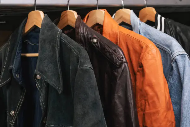 Photo of Various vintage jackets on clothing rack in second hand store