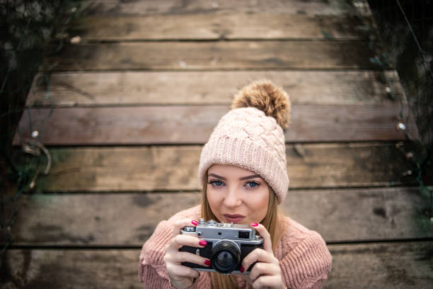 A young beautiful woman spends time in nature, enjoying a beautiful sunny autumn day