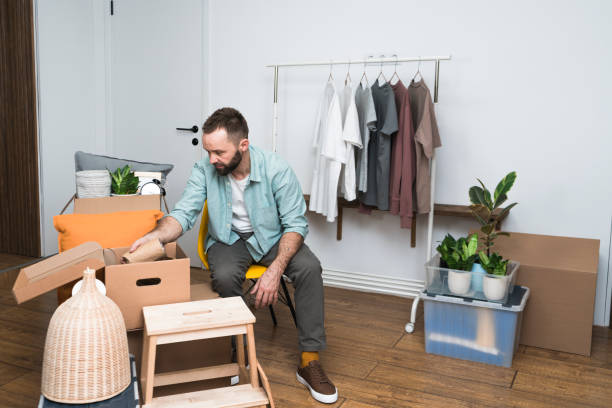 istock Mature man unpacking things from boxes while moving in new apartment. 1404655542