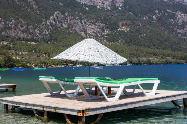 istock Sunbeds and umbrellas in the water on the beach 1404656685