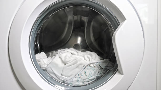 istock White laundry spins in washing machine drum with water 1404658525
