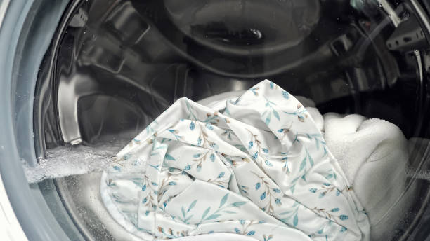 istock White laundry in washing machine with water and foam 1404658534