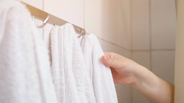 istock Woman pulls curtain and takes towel during taking shower 1404658650