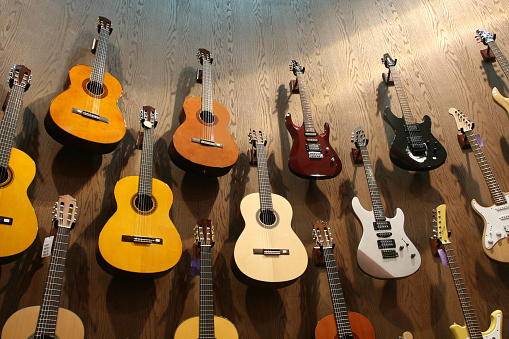 Guitar collection hanging from a music shop.