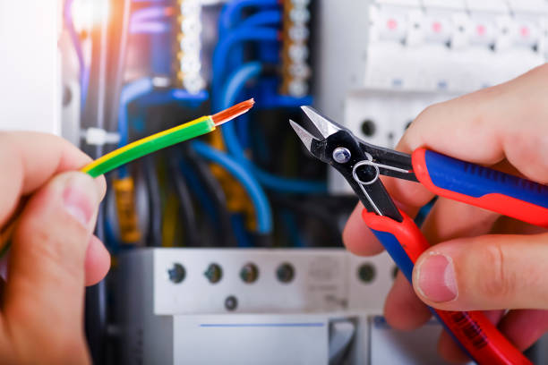 Electrician cutting wires detail. stock photo