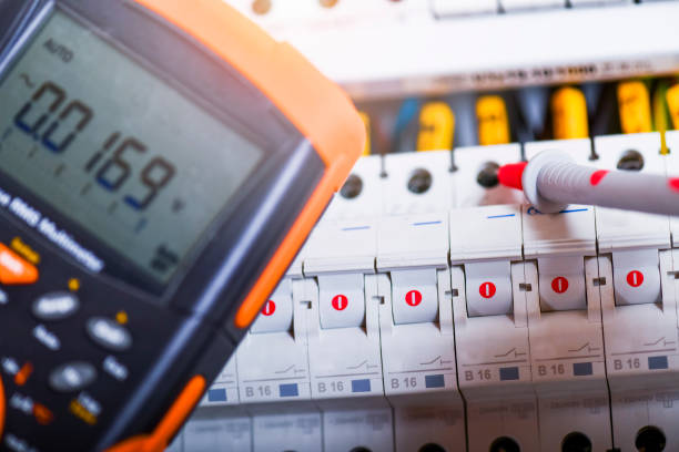 electrician installing electric cable wires and fuse switch box. - art installation imagens e fotografias de stock