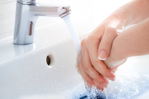 istock Washing hands under the faucet with water and soap. 1404662037