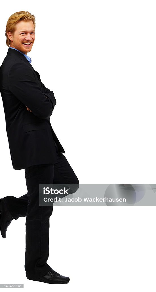 Uomo d'affari pendente sulla parete - Foto stock royalty-free di Appoggiarsi