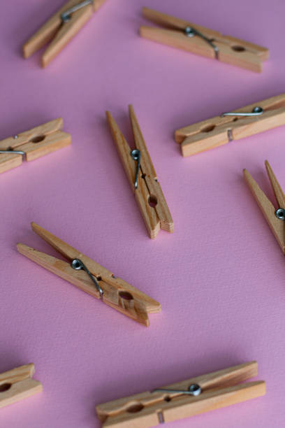 istock Set of decorative clothespins on a pink background 1404663772