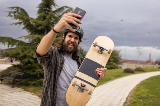 istock Male skateboarder taking selfie with mobile phone 1404664901