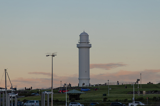 Wollongong, Australia - June 12, 2022: Flagstaff point lighthouse at sunset time.