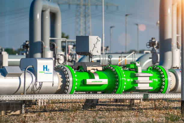 Green Hydrogen renewable energy production pipeline - green hydrogen gas for clean electricity solar and windturbine facility stock photo