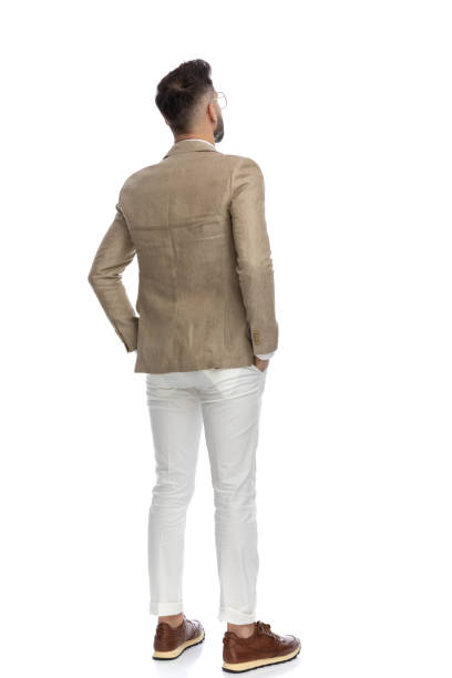 istock businessman holding his arms in his pockets 1404665601