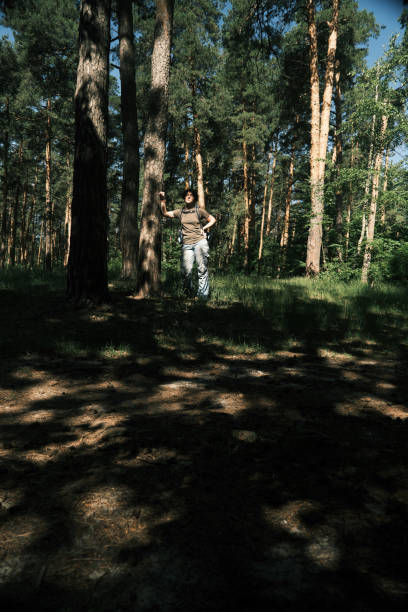 istock Female backpacker is hiking in forest 1404666935