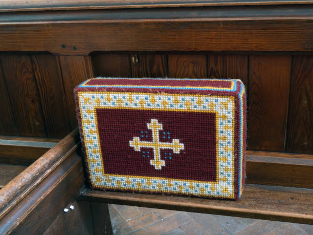 Church kneeler on wooden pew, for Christian prayer. Old church kneeler on wooden pew, for Christian prayer. kneelers stock pictures, royalty-free photos & images