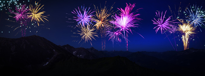 Fireworks Event Festival New Year's Eve Party Holiday background banner - Beautiful view of landscape panorama in the mountains, with colorful firework in the night