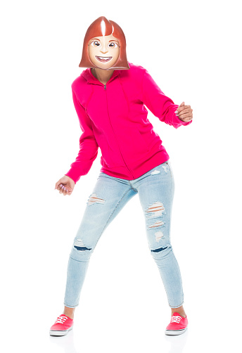 Front view of aged 20-29 years old who is beautiful with black hair generation z young women exercising in front of white background wearing jeans who is winking and showing emoticon ( emoji )