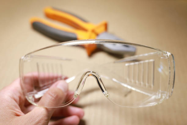 istock Protective glasses in hand, eye safety. 1404670104
