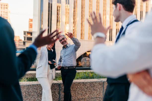 istock Businesspeople waving outdoors 1404670376