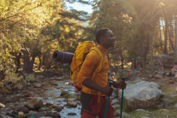 istock Young hiker crossing mountain stream 1404670411
