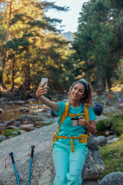 istock Young hiker taking selfie in mountain forest 1404670418