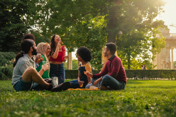 Small group having picnic at park stock photo