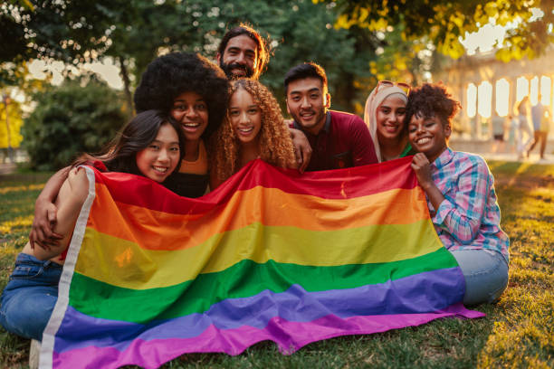 istock Gay friends with pride flag in park 1404670537