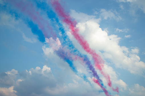 Colourful vapor trails in the sky on a warm sunny day