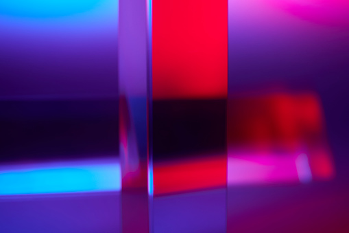 Abstract triangular prism glass with red and blue lights background