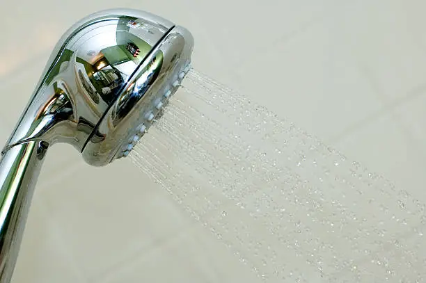 Showerhead with bathroom interior reflection