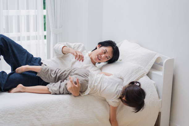 istock Little girl playing in bed with her daddy 1404672423