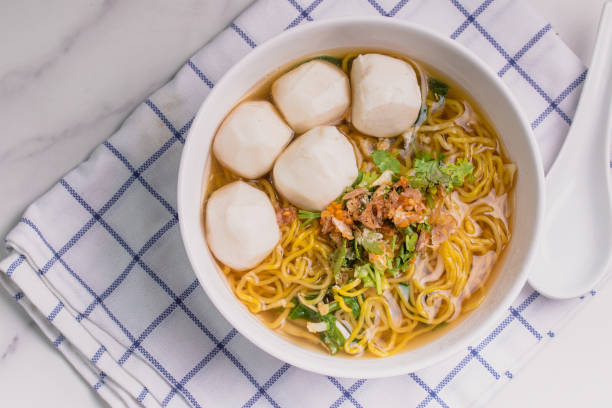 istock Egg Noodles with Fish Balls, Clear Soup Noodles in White Cups 1404674448